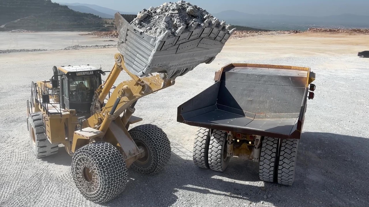 Big Machines At Work: Caterpillar 992K Wheel Loader Loads Cat 777F Dumpers At Quarry - Interkat SA